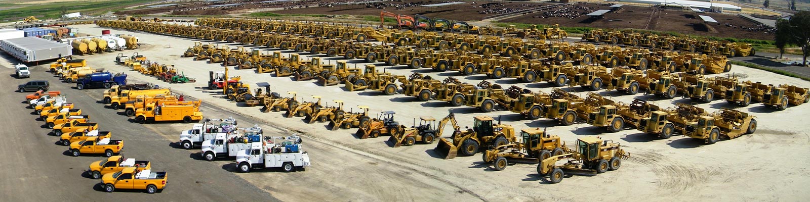 Rows of scrapers, loaders, graders and service trucks parked across the San Jacinto equipment yard.